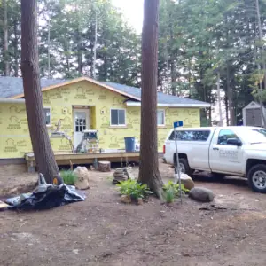 A full new roof was installed and the exterior was prepared for installation of new vertical board and batten wood siding.