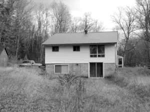 An image of the previously existing home, before wood frame demolition & construction.