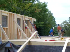 Carpenters are busy with framing the new custom home, following demolition & disposal of the existing wood frame building.