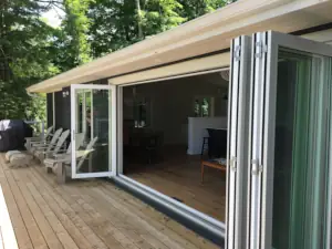 The 15-foot bifolding glass doors with roll-up insect screen allow the cottage interior to feel like a large, very comfortable outdoor space while offering the comforts of home.