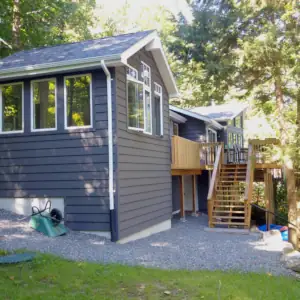 The cottage extension is integrated perfectly into the original cottage exterior by careful selection of siding profile and skillful application of exterior siding paint.