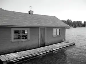 A photo shows the deteriorated condition of the original boathouse before construction of the new boathouse.