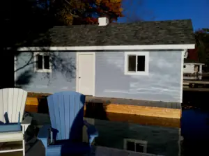 The sun shimmers on the exterior of the new boathouse built by Port Sandfield Dockworks and Lakewood Construction.