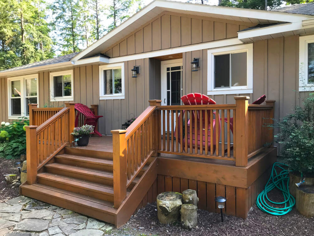 A glowing cedar deck in the sunshine at a cottage on Dickie Lake in the Township of Lake of Bays, Muskoka, Ontario.