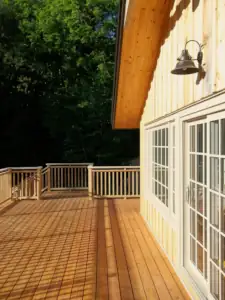 A sliding patio door connects the house linving space to a large deck overlooking the Oxtongue River.