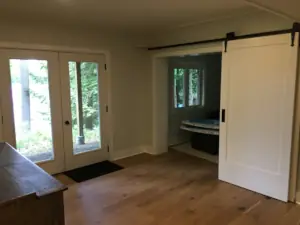 An open area in the basement serves as a landing area, circulation space and off-season storage zone for summer toys from the shore at Lake Muskoka.